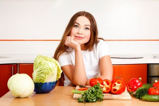 Fille à une table avec des légumes